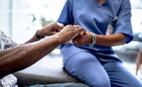 Nurse holding patient's hands