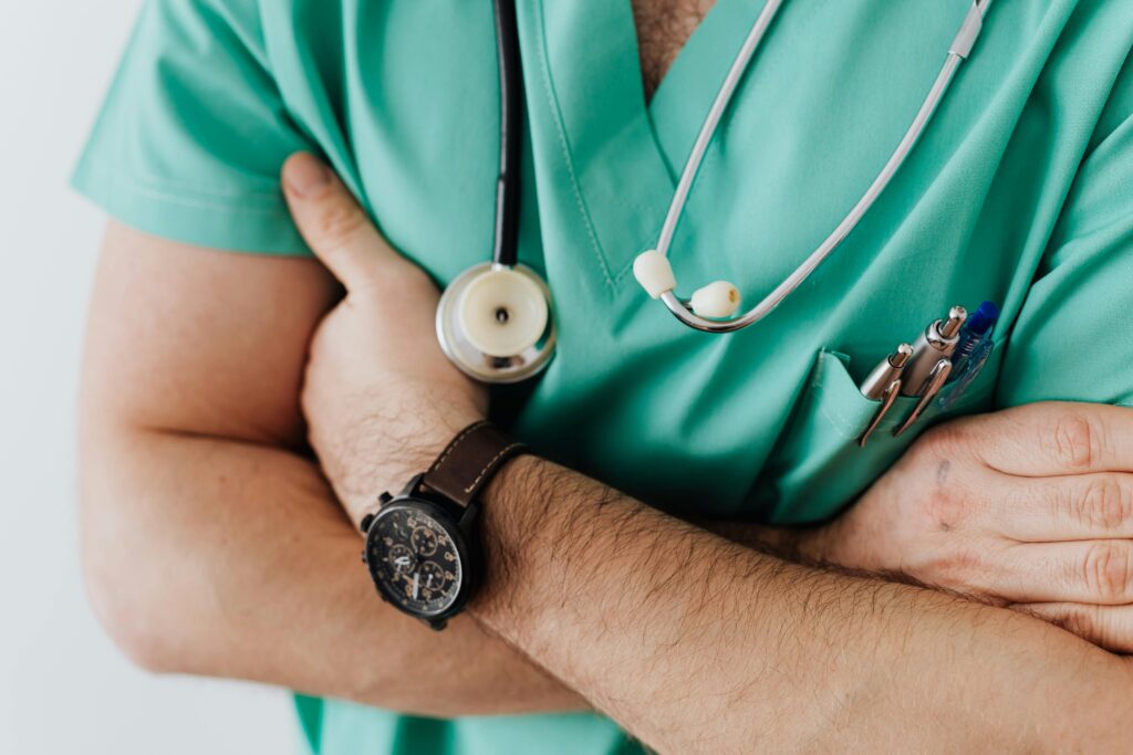 pexels-photo-4021779-4021779 Doctor in scrubs with folded arms and stethoscope, symbolizing confidence in healthcare.