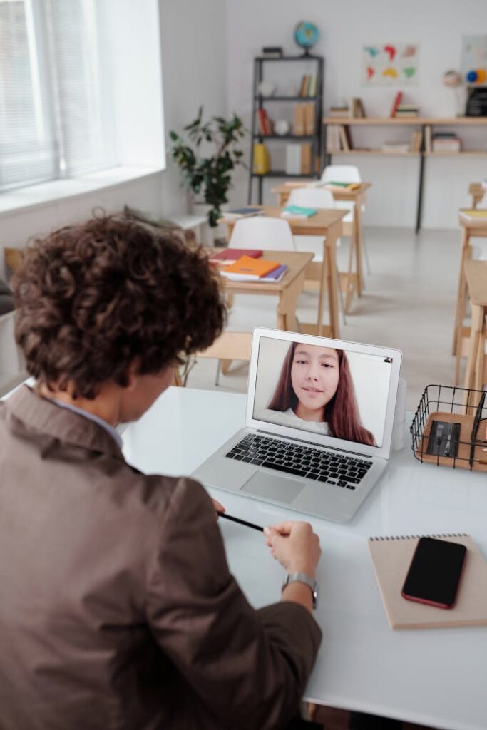 pexels-photo-5212657 A student in a classroom takes an online lesson via a video call, illustrating modern education technology.